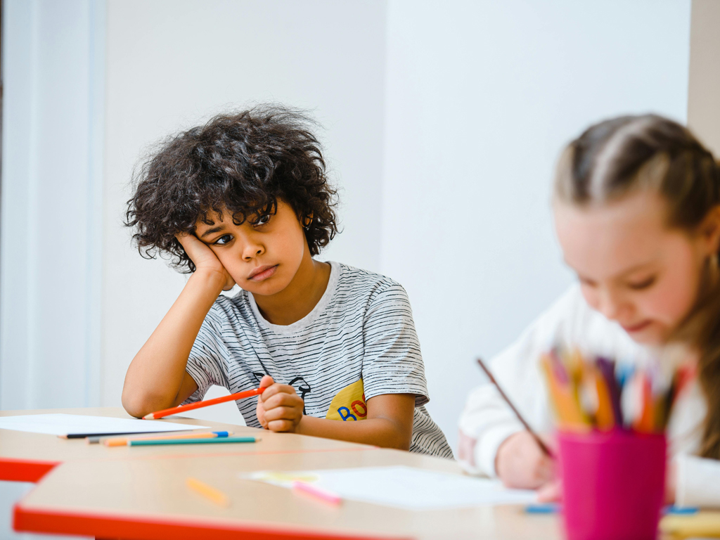 a young boy struggling in class