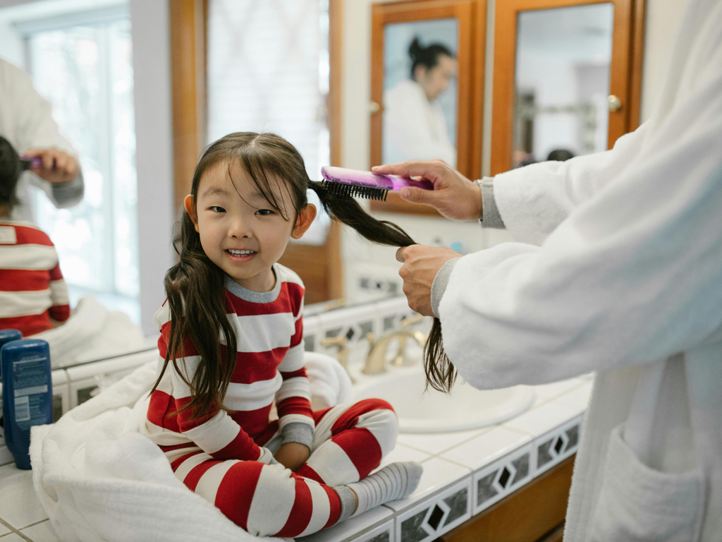 mother doing her daughter's hair