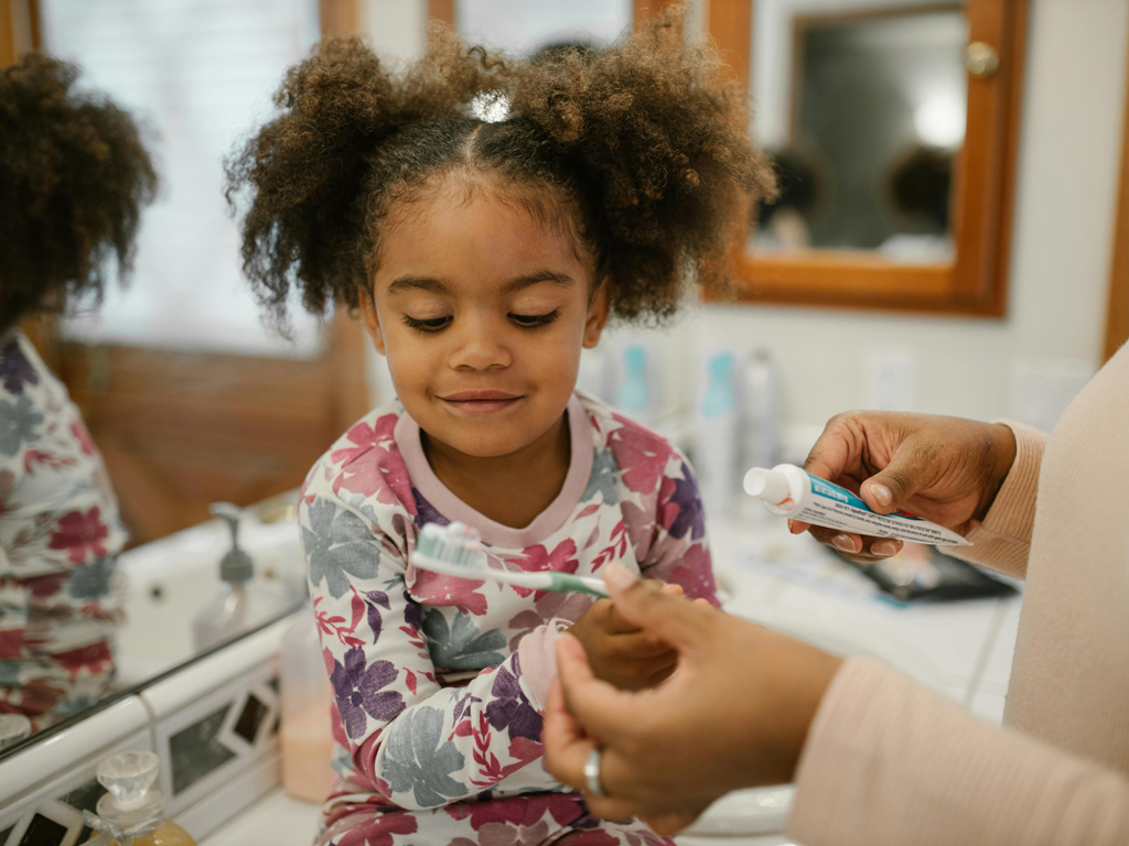 girl getting ready to brush her teeth