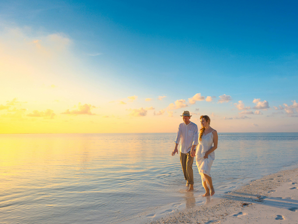 a couple walking along the beach