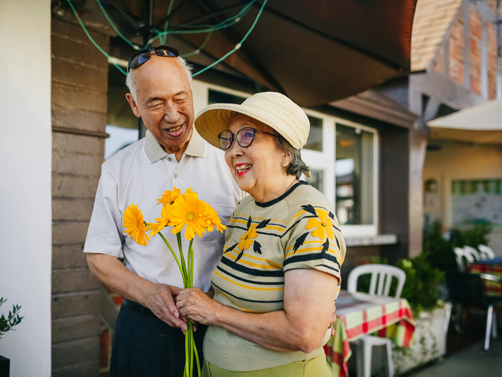 elderly couple smiling outdoors