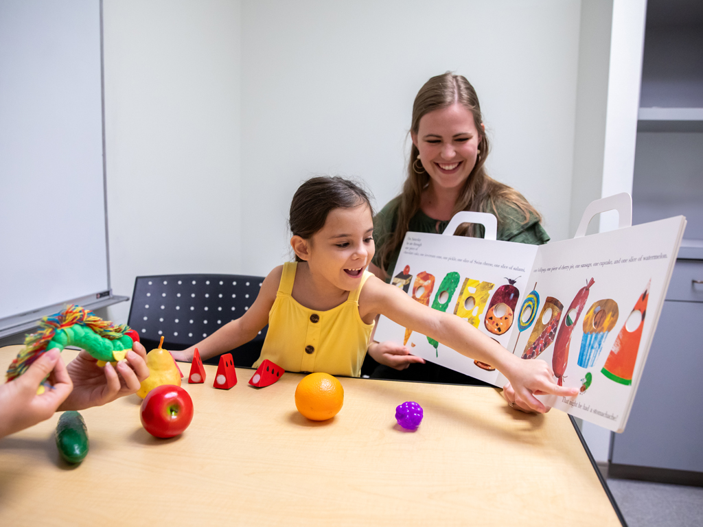 teacher reading a book to a child