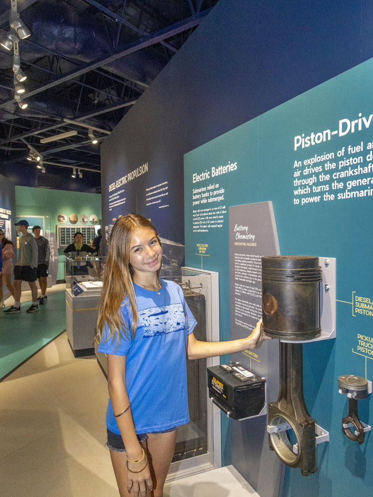 teen interacting with a display at the Pacific Fleet Submarine Museum
