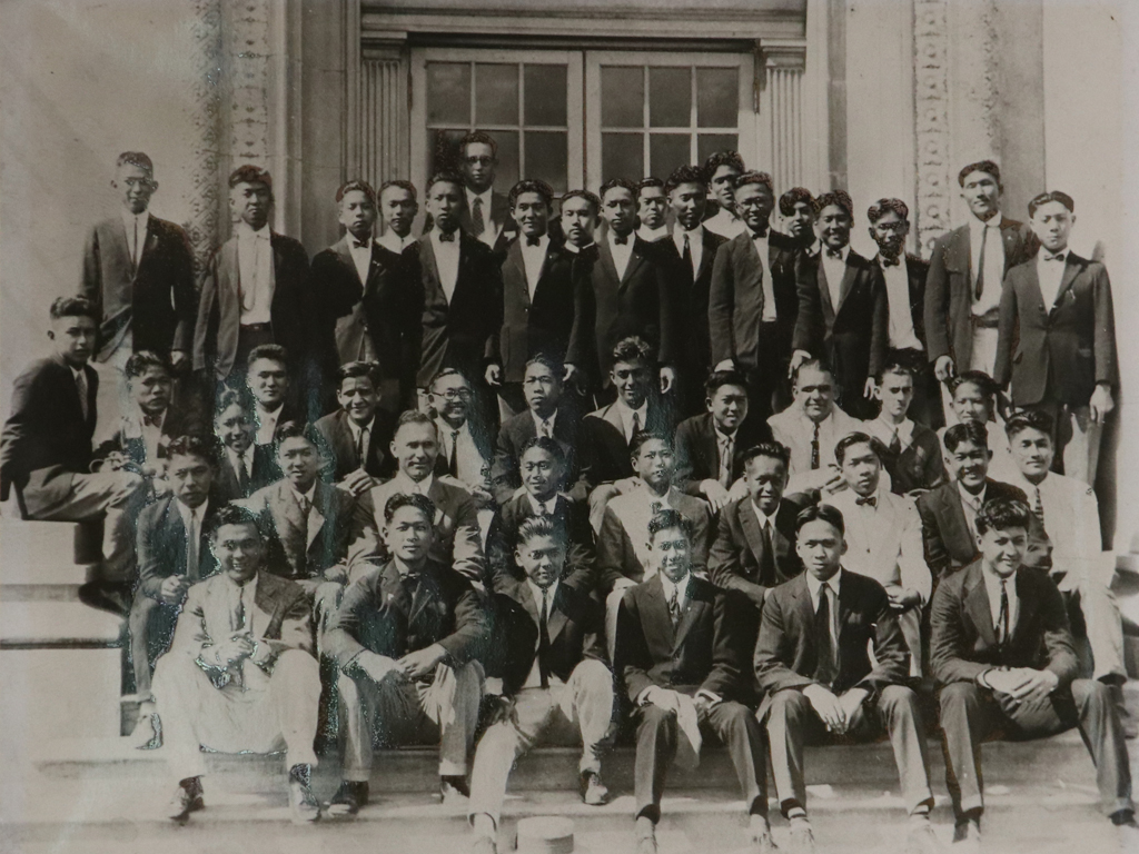 an old photo of males teens in suits