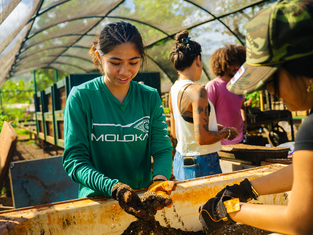 teens sorting through soil