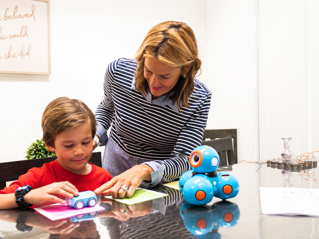 mom showing her young son a toy car