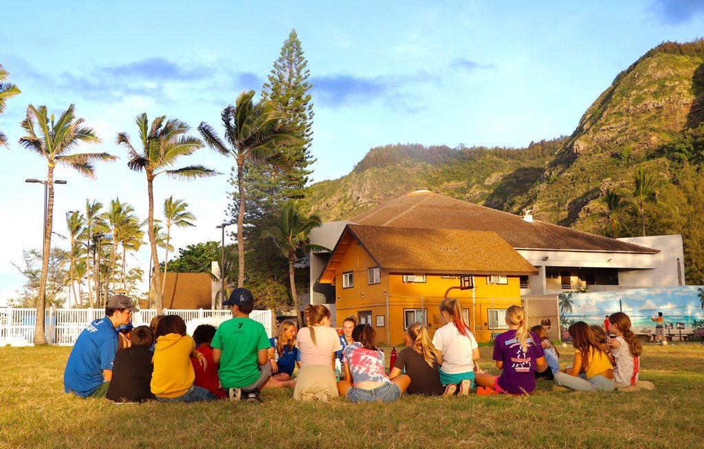 Overnight resident campers at Camp Erdman sitting on the lawn