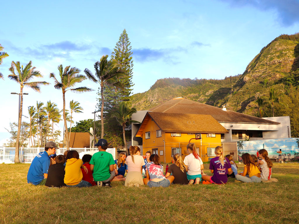 Overnight resident campers at Camp Erdman sitting on the lawn