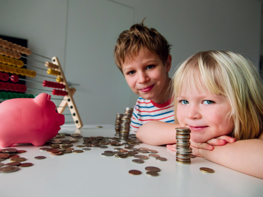 boy and girl counting coins on a table