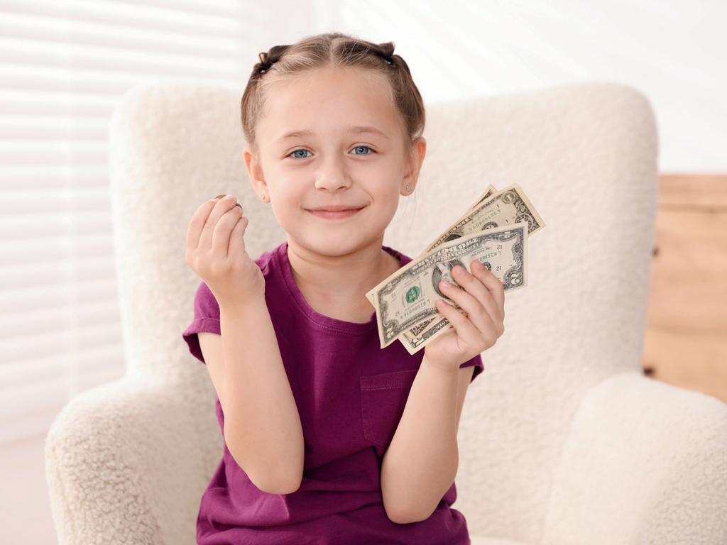 child with a handful of cash