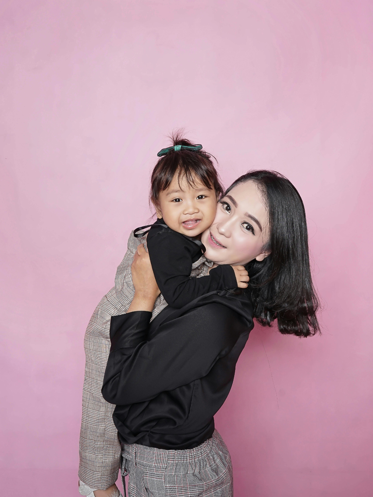 mom holding her daughter
