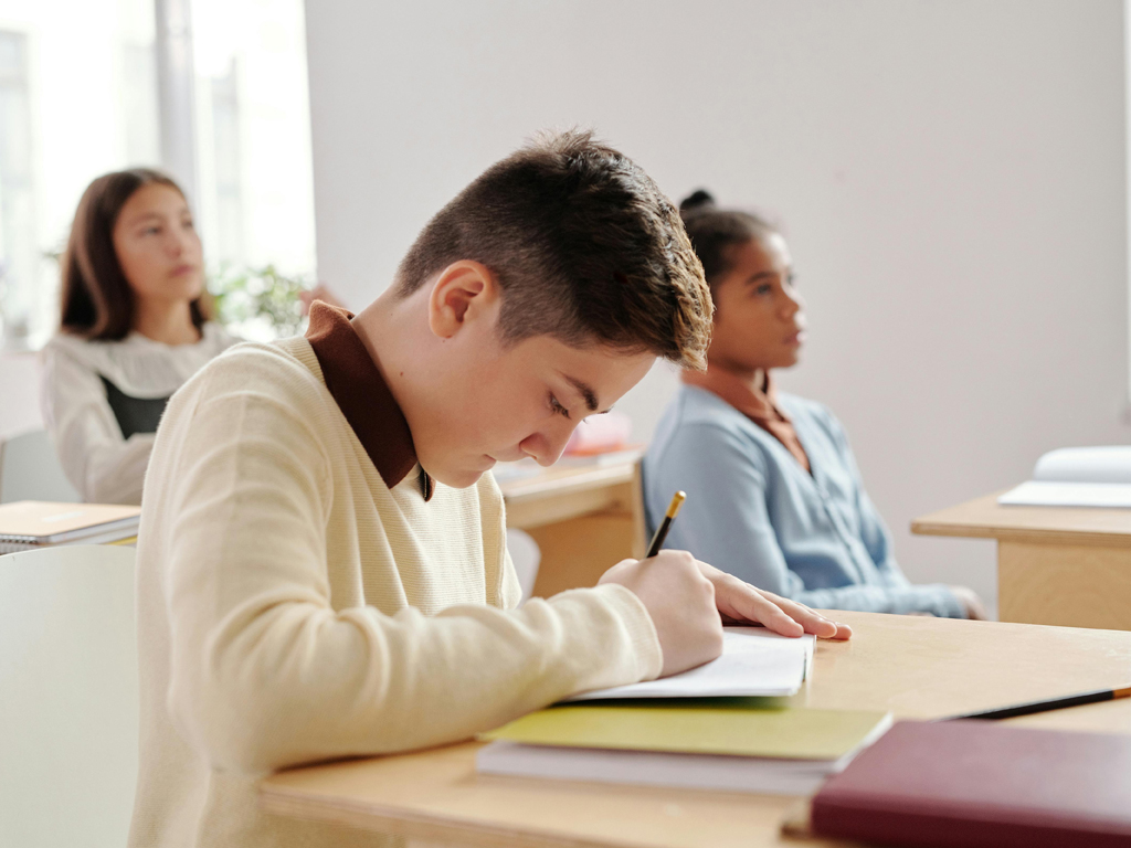 young male being studious in a classroom