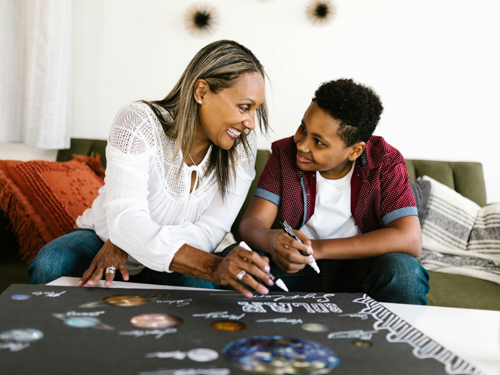 mom working on a poster with her son