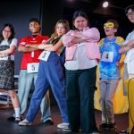 group of teens performing on stage
