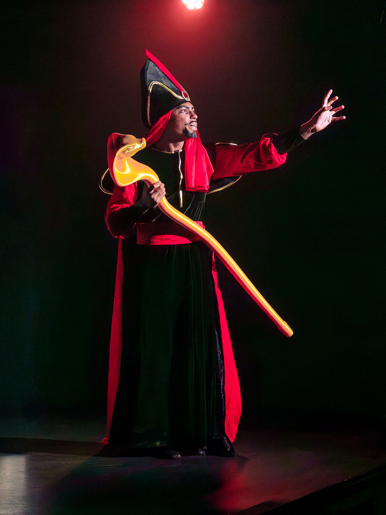 male dressed as Jafar performing on stage