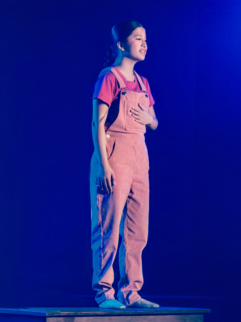 teen performing in a show on stage
