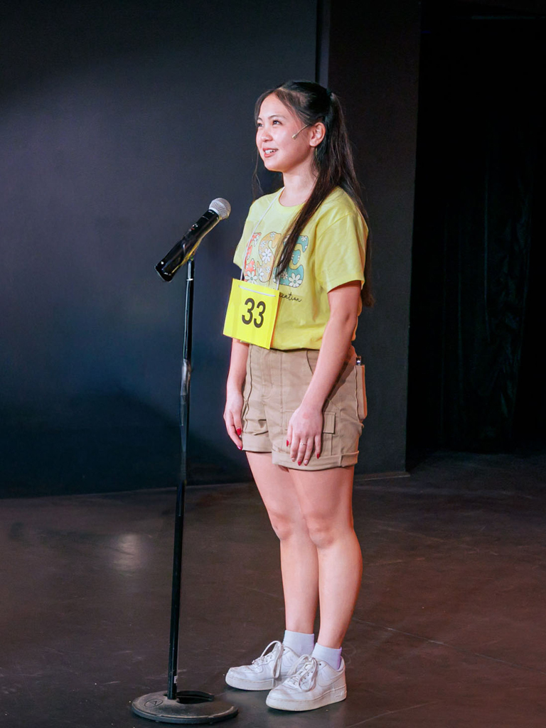 teen auditioning in front of a microphone