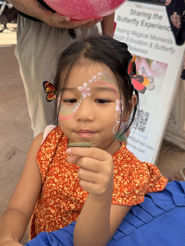 girl with a caterpillar on her finger