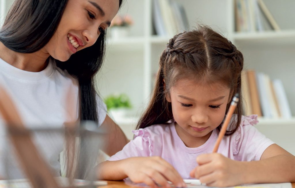 babysitter helping child with homework