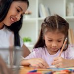 babysitter helping child with homework
