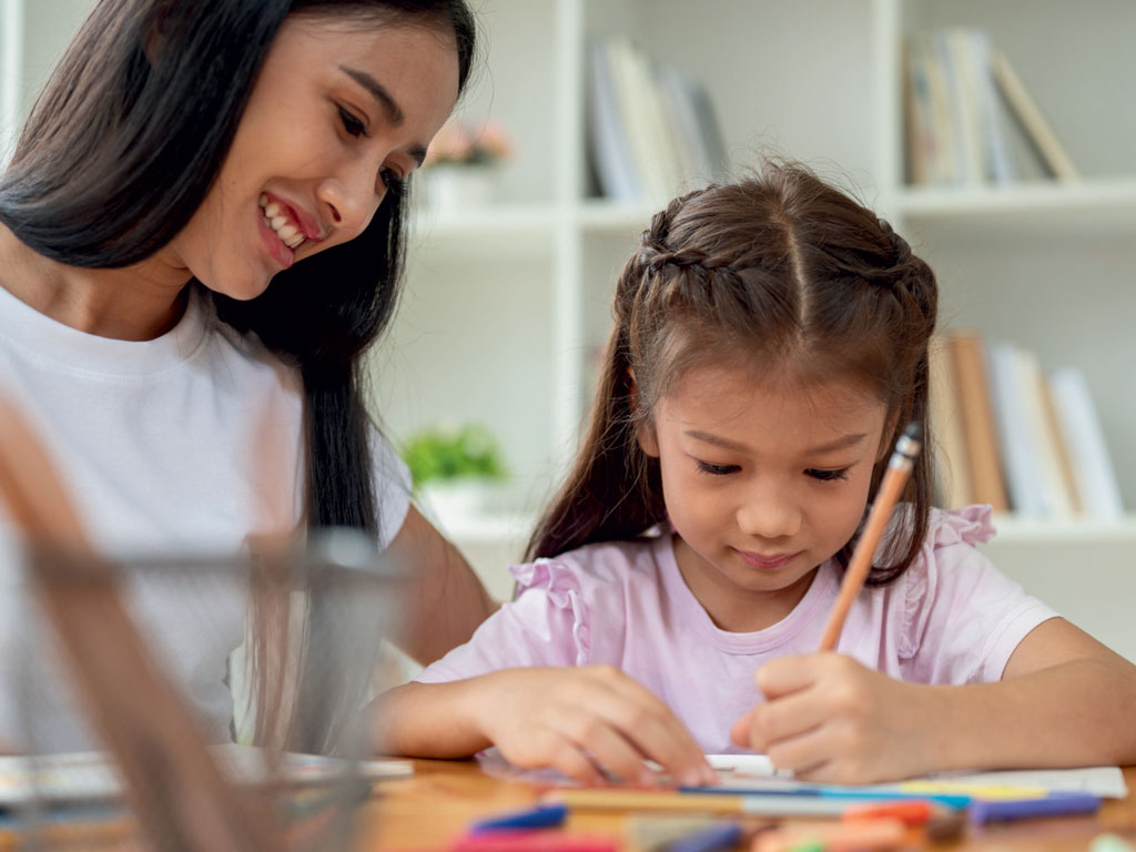 babysitter helping child with homework