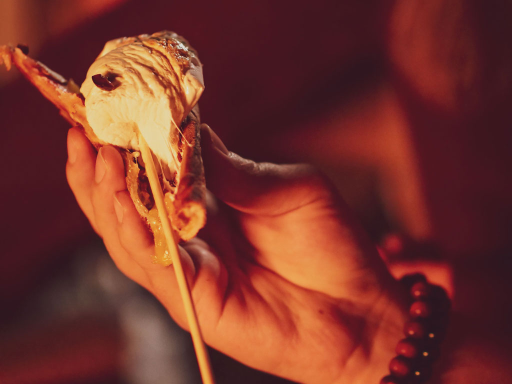 toasted marshmallow being removed from skewer