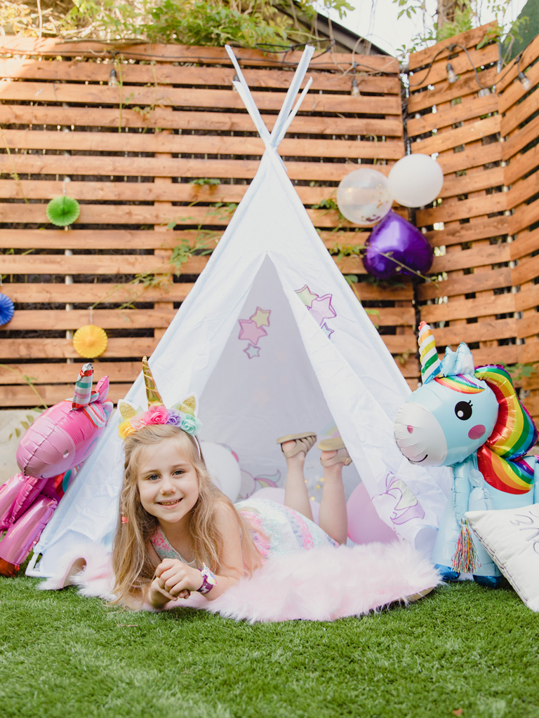 girl in a unicorn themed tent