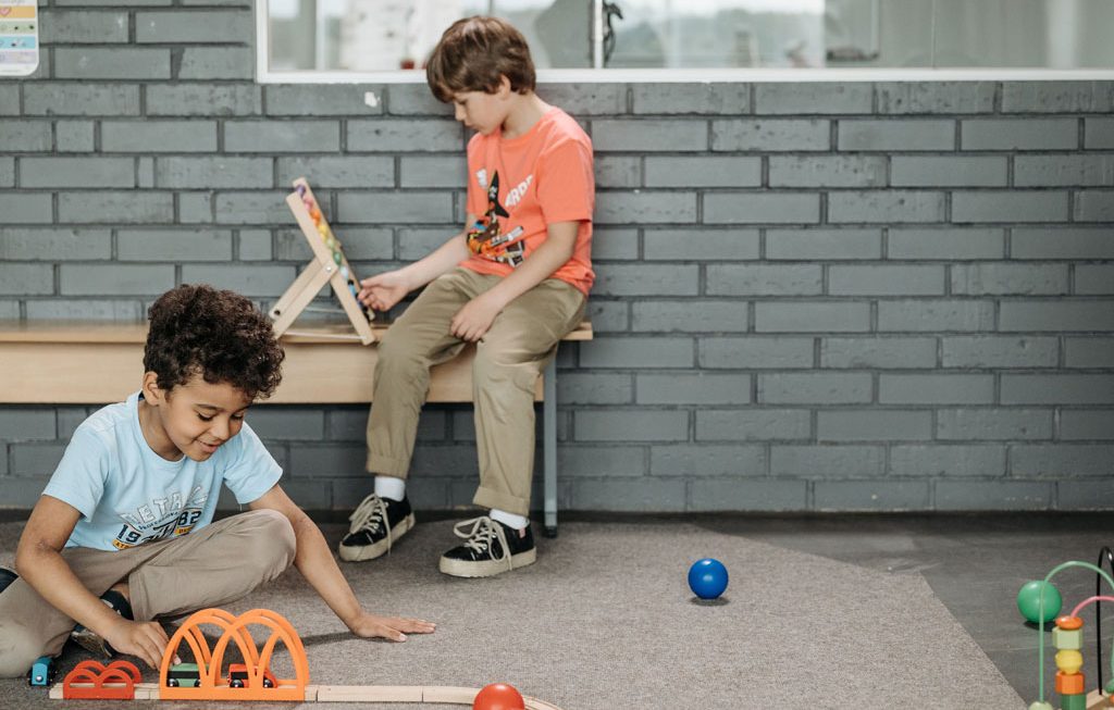 two boys playing with toys