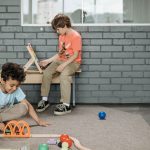 two boys playing with toys