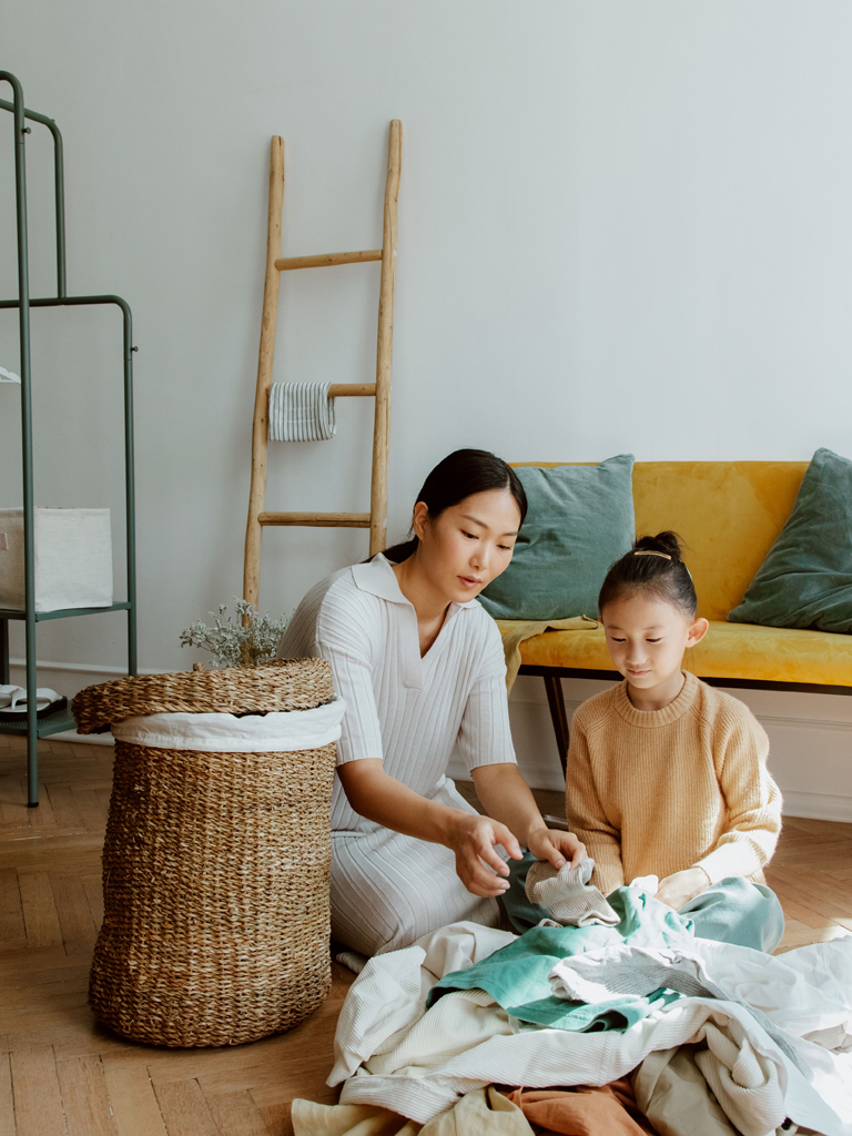 mom and daughter getting laundry prepared