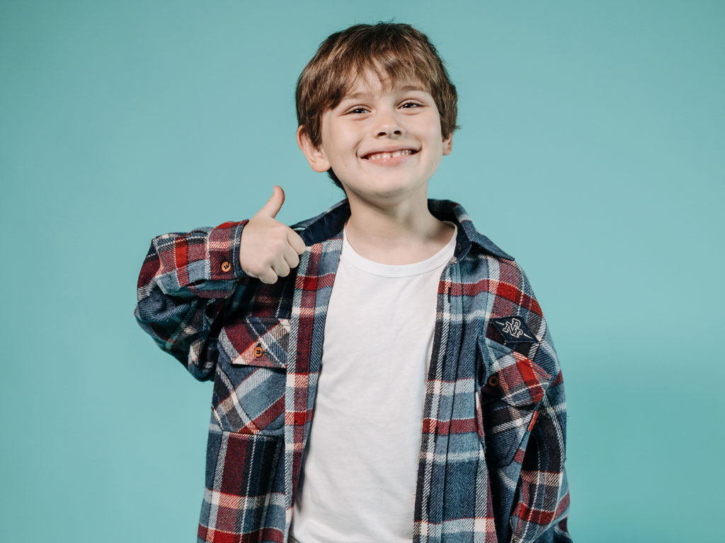 young boy with thumbs up