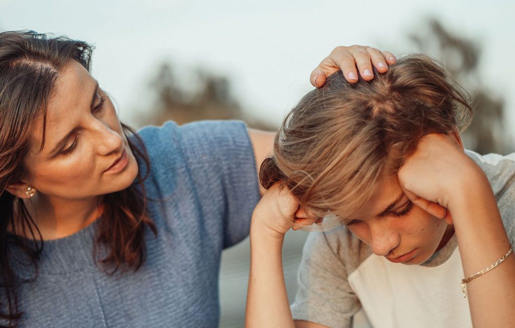 mom comforting distraught daughter