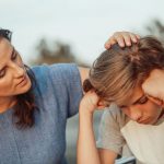 mom comforting distraught daughter