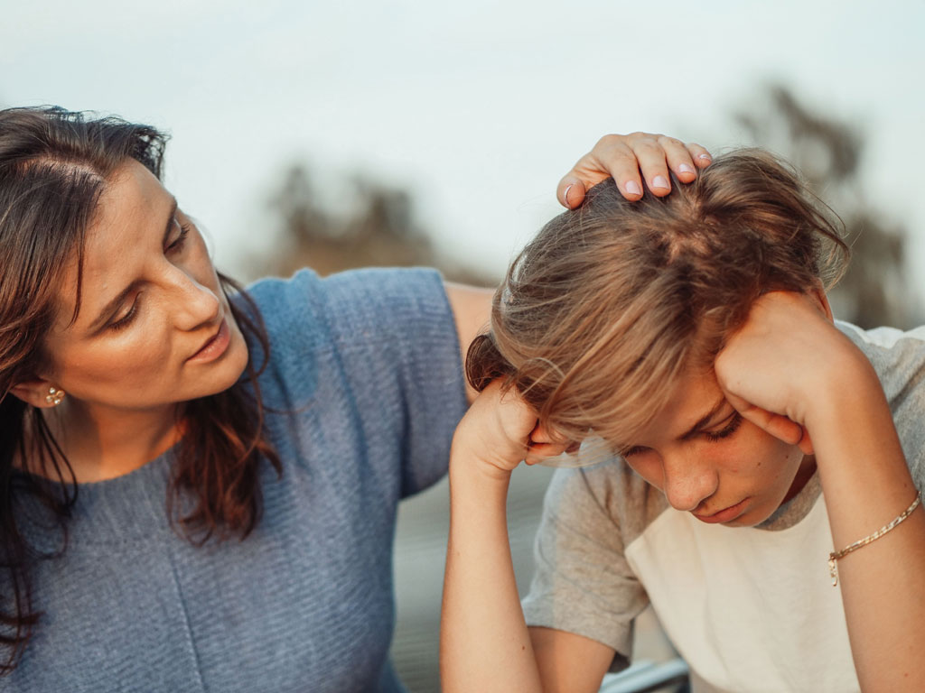 mom comforting distraught daughter