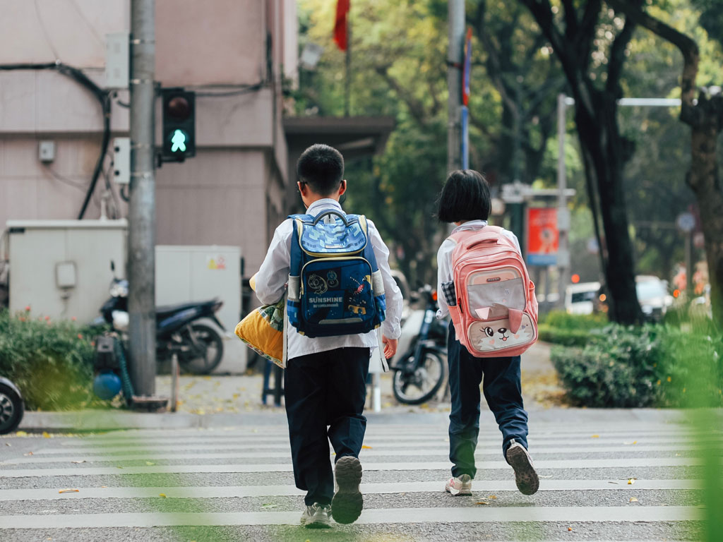 elementary age boy and girl walking to school