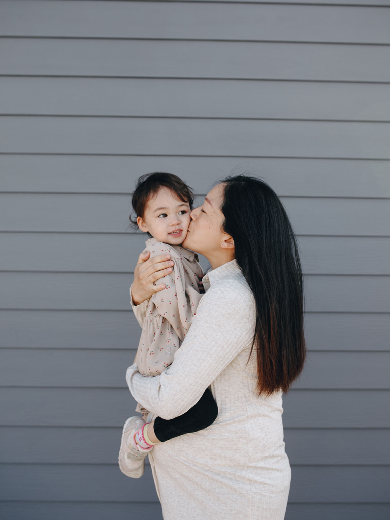 mom kissing her child