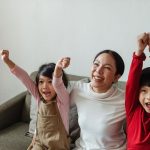 mom smiling with her young son and daughter