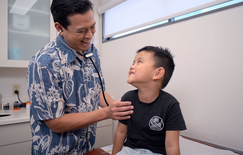 child being examined by his pediatrician