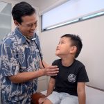 child being examined by his pediatrician