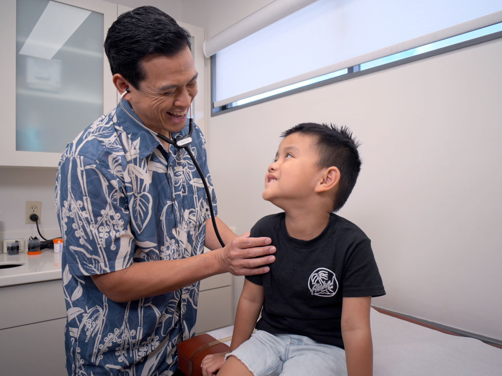child being examined by his pediatrician