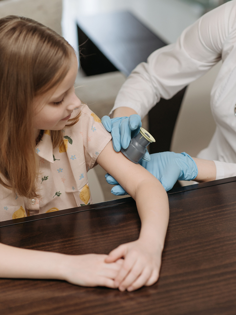 child being examined by her pediatrician
