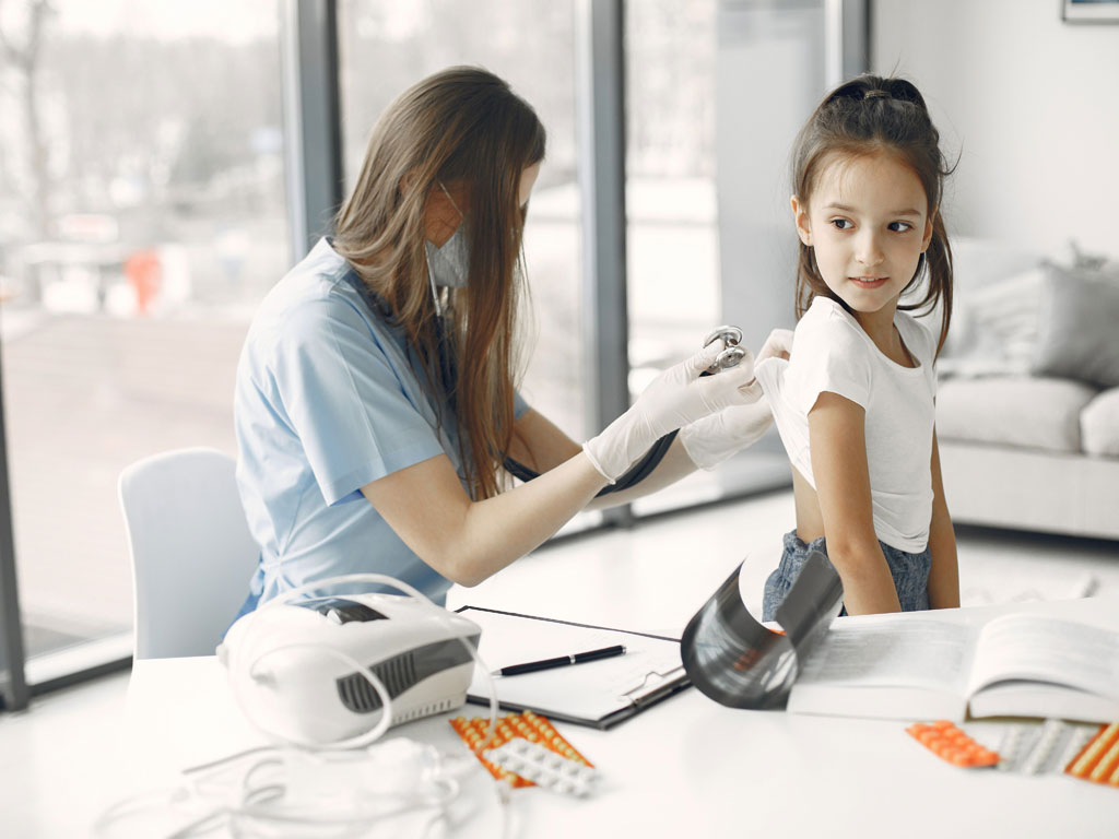 child being examined by her pediatrician